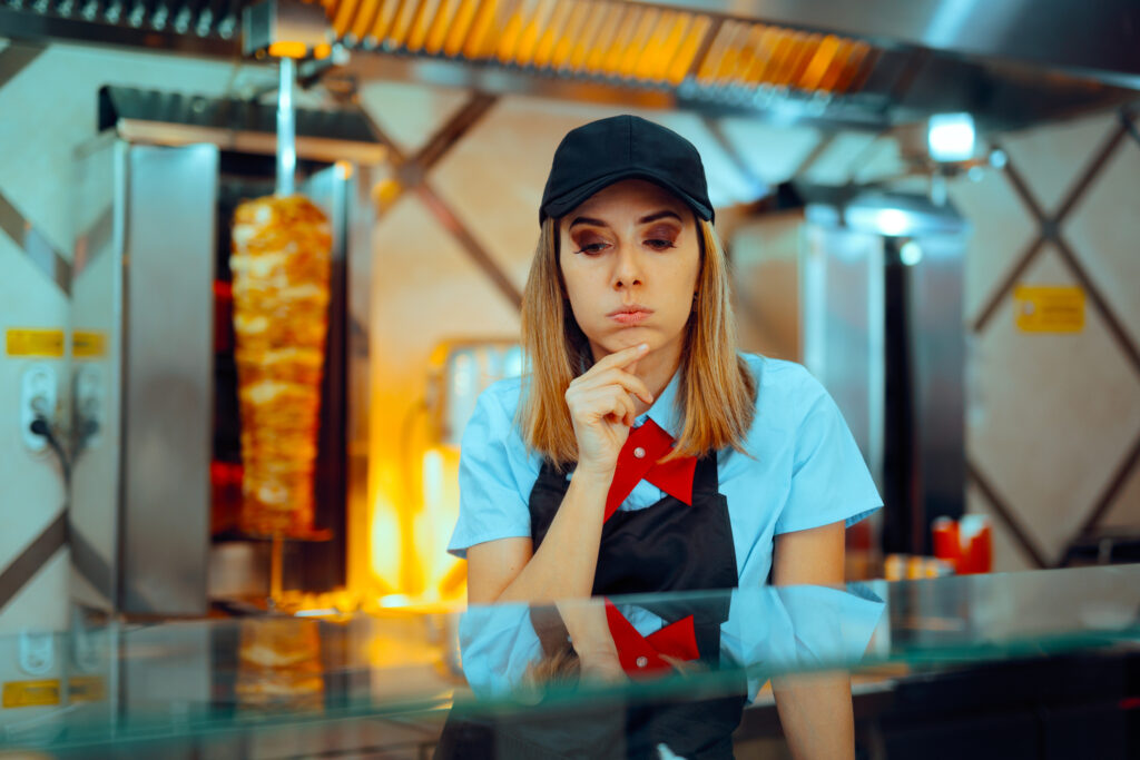 Dissatisfied and distracted restaurant staff member