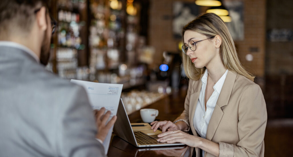 Restaurant owner with advisor reviewing key performance metrics.